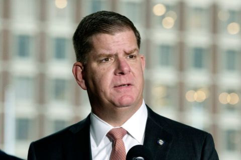 Marty Walsh in a suit poses a picture.